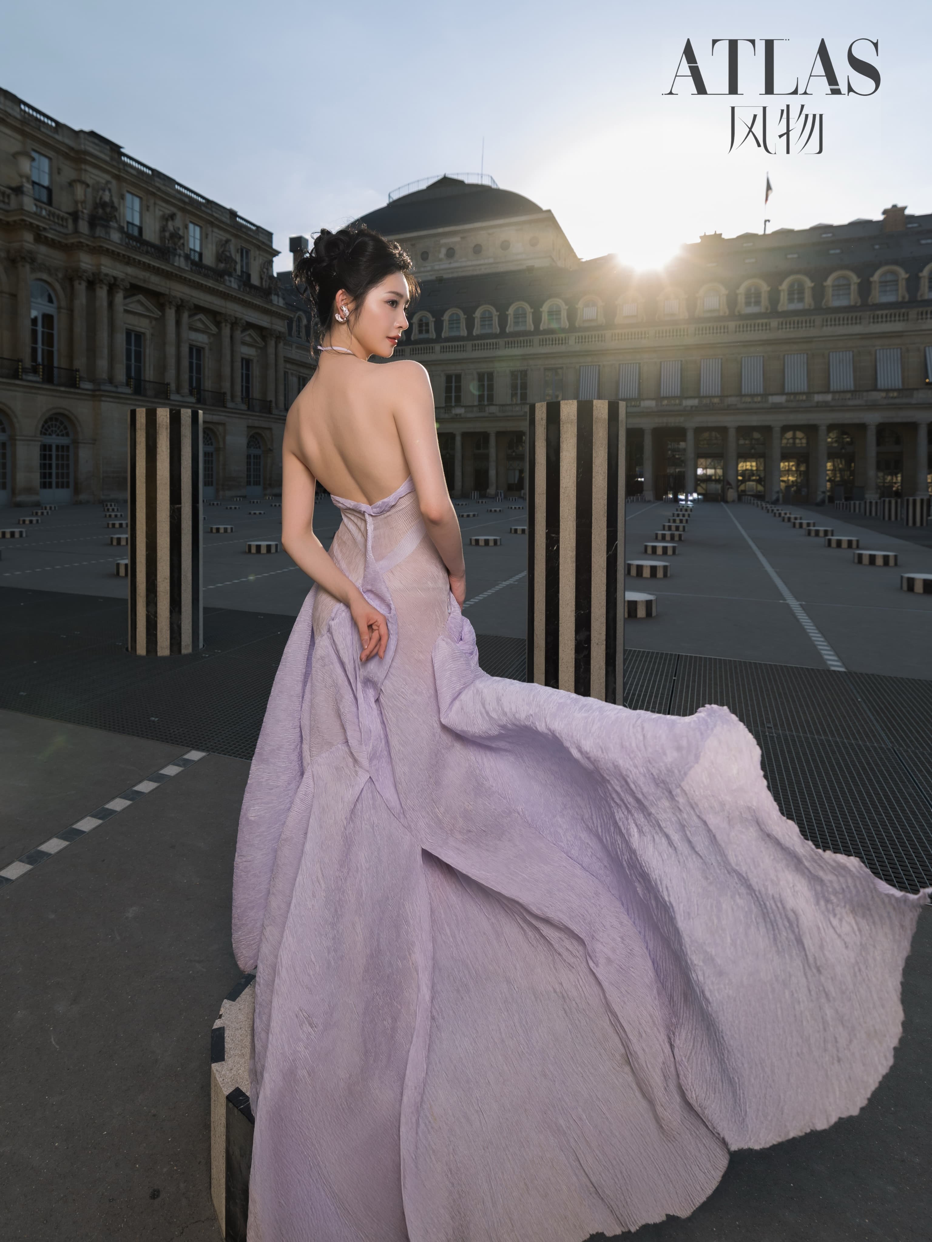 Zhou Jieqiong turns in a lavender dress as its train moves across the Palais Royal courtyard.