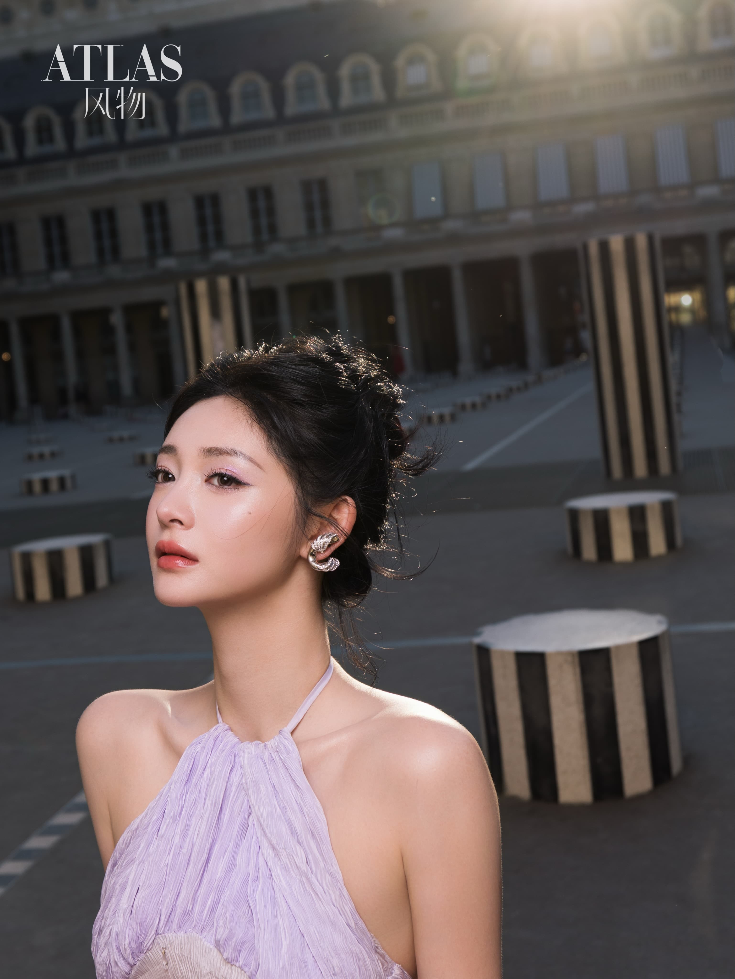 A close portrait of Zhou Jieqiong in the Palais Royal courtyard at sunset.
