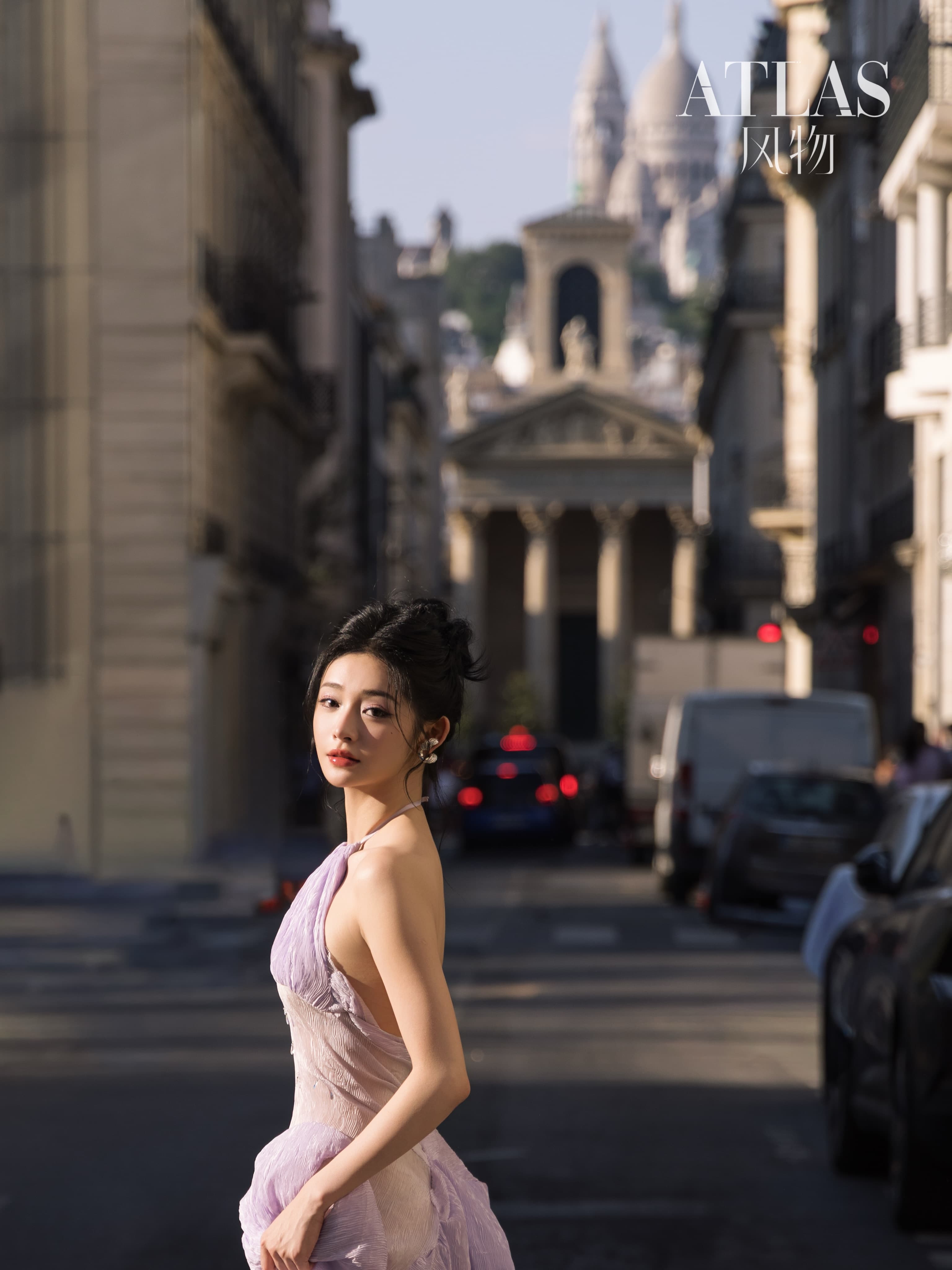 Zhou Jieqiong turning on a Paris street with Sacre-Coeur in the distance.