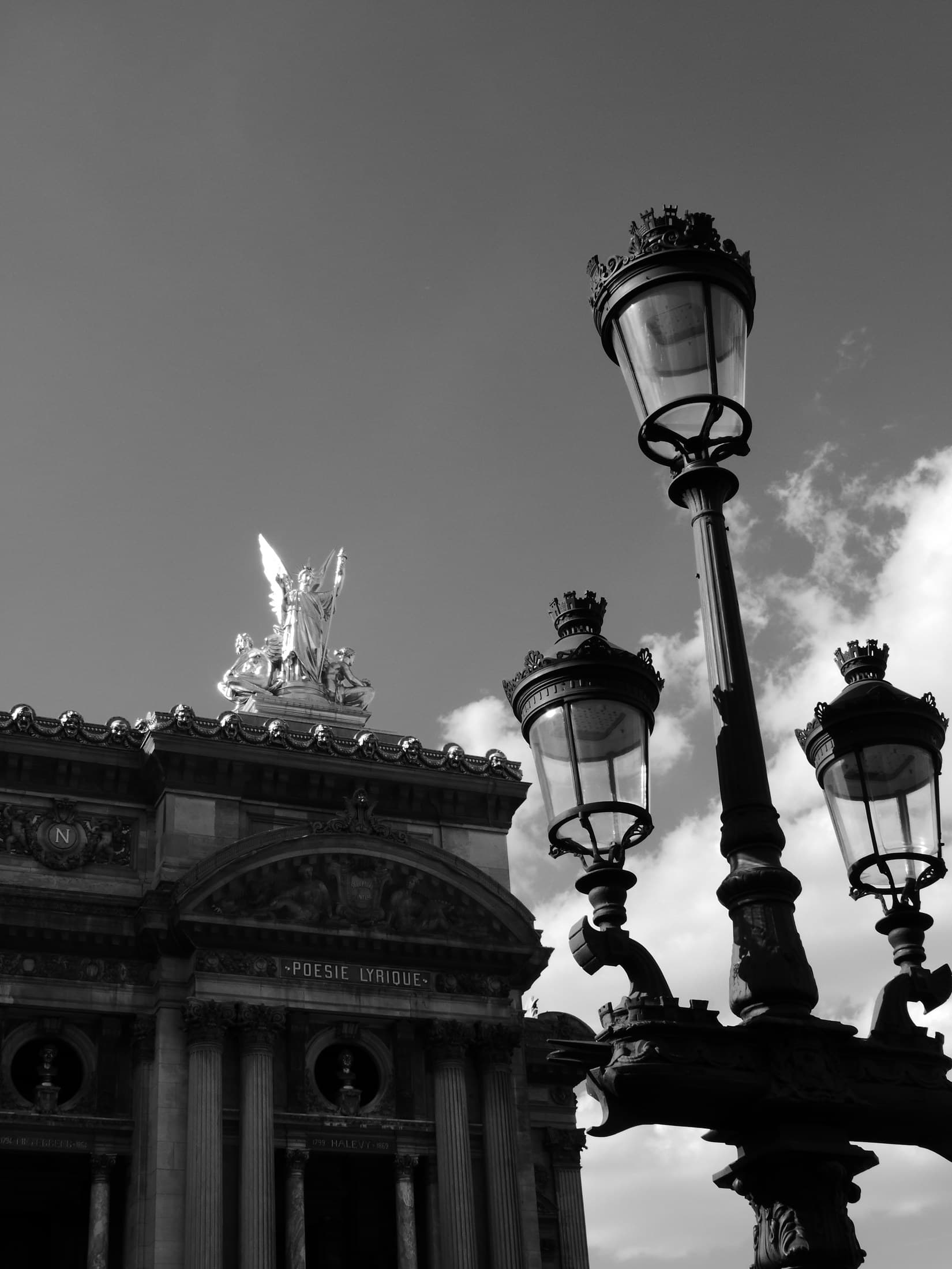 Black-and-white Paris street lamps near the opera district.